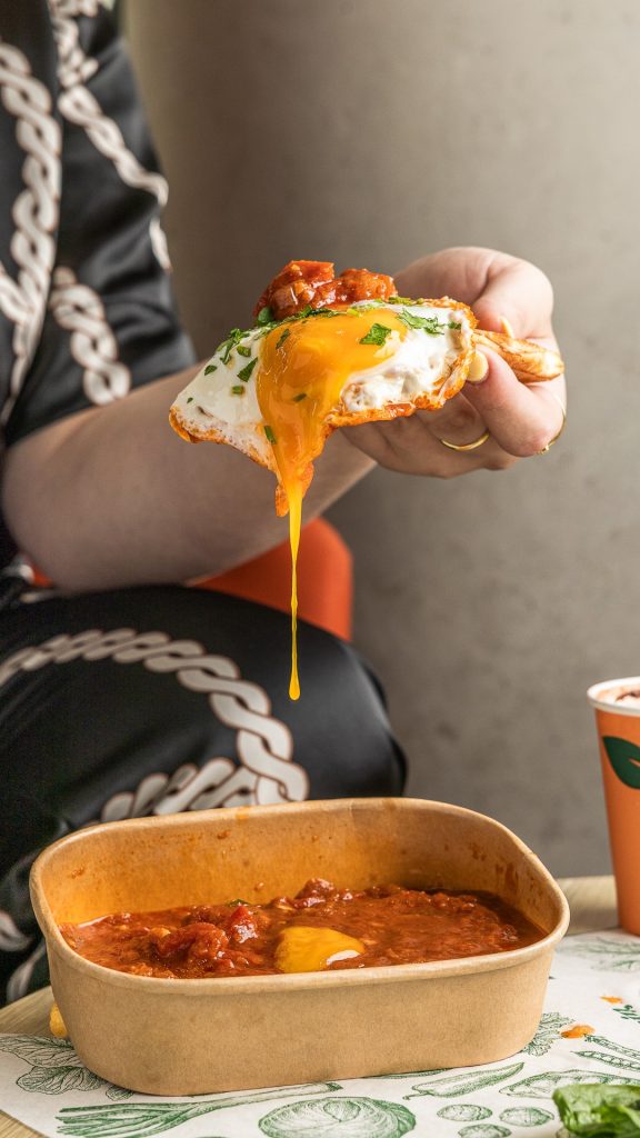 LifeGrain Shakshuka with Fried Egg and Toast Close up with egg yolk running down